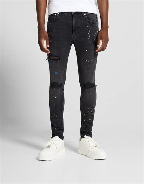 Jeans super skinny strappati effetto pittura .